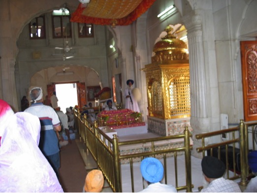 The golden enclosure at the center of the Akāl Takhat contains Sikh historic weaponry